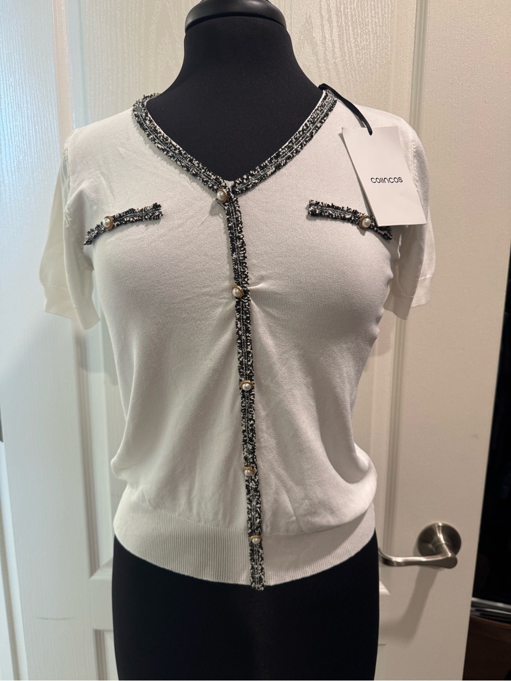 Cosmoss White Short-Sleeve Knit Top with Black Trim and Pearl Buttons